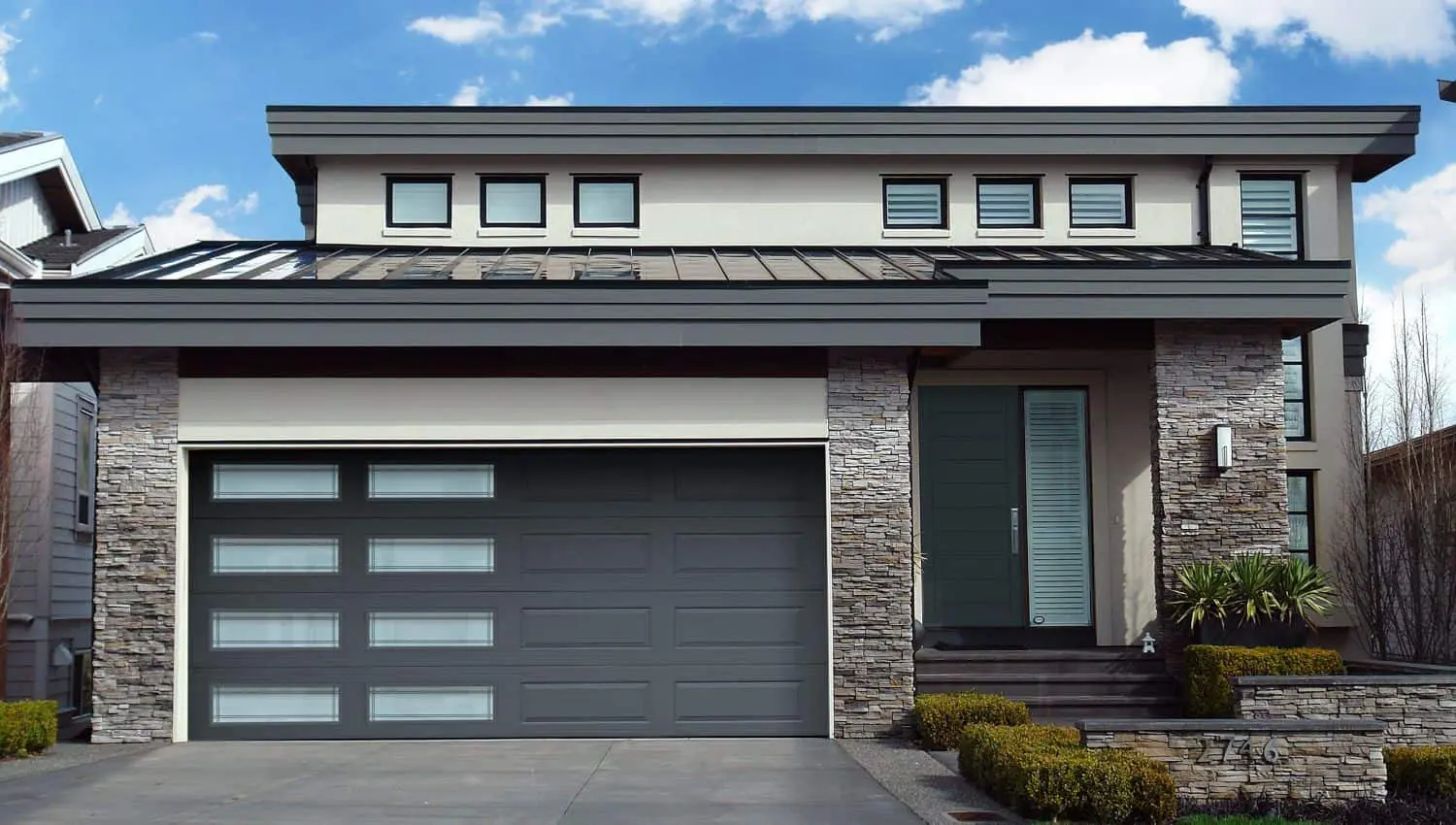modern gray garage door with window panels