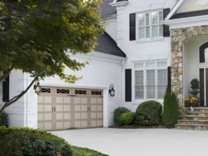 tan garage door on white brick house