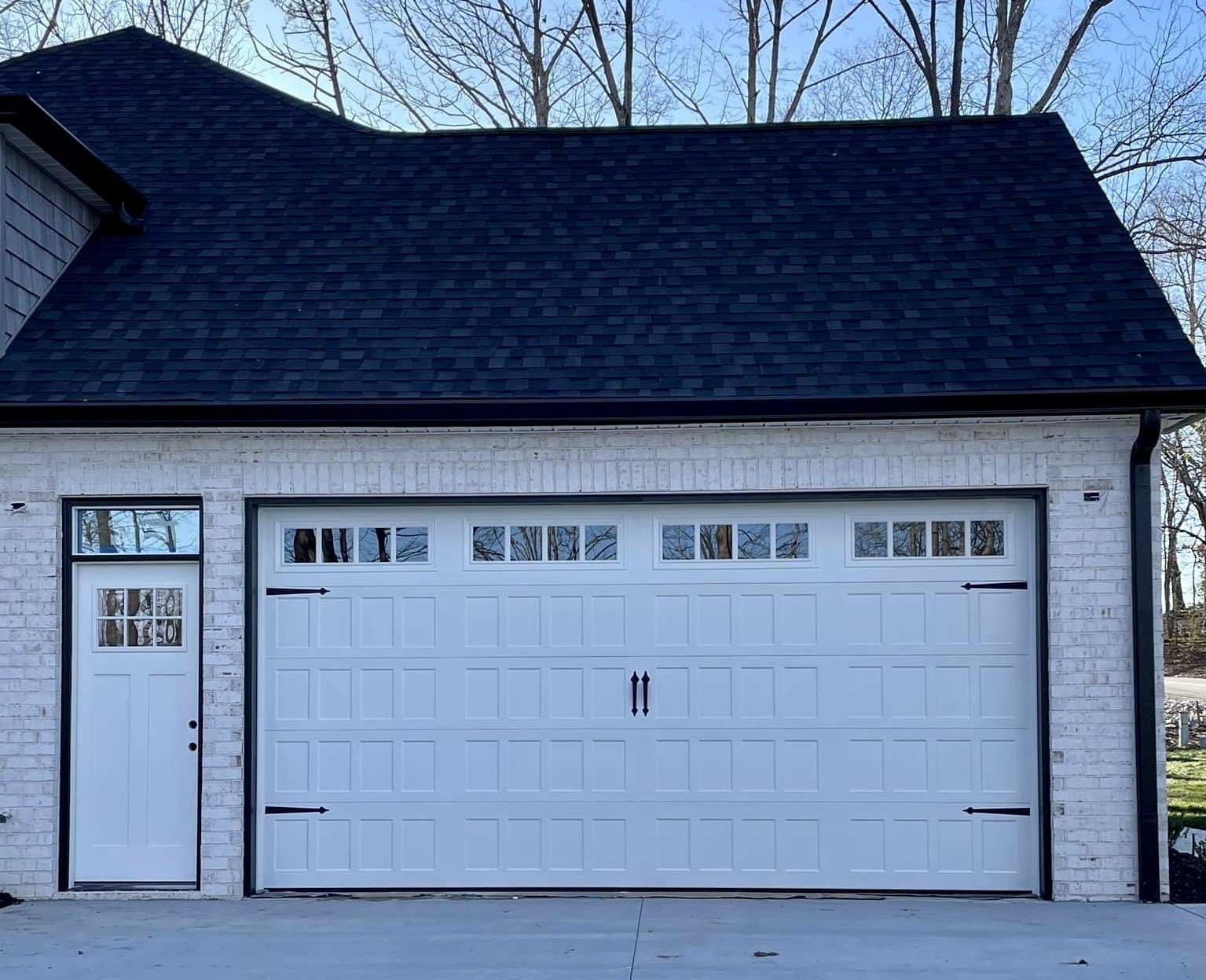 white automatic door with decoratve hardware and windows