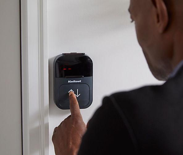 man pressing garage door opener button